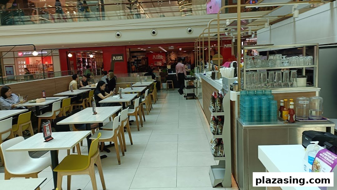 An interior view of Secret Recipe, showing customers dining at tables and a service counter.