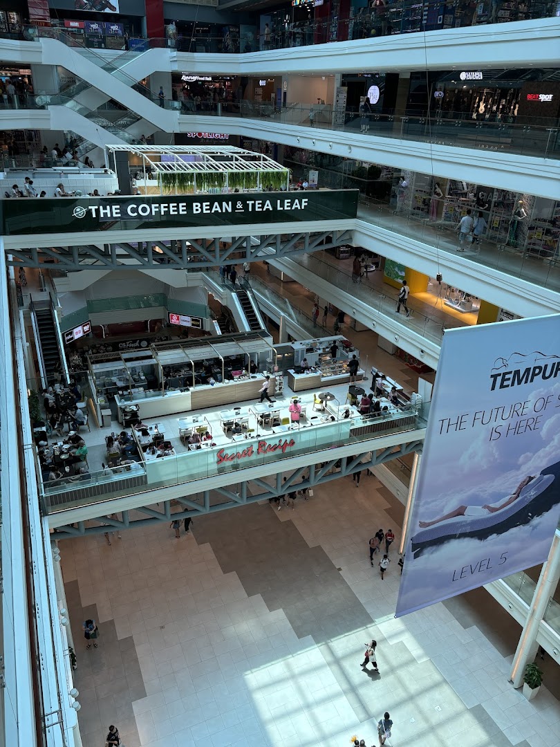 Aerial view of a bustling mall interior featuring Secret Recipe cafe with patrons enjoying their meals.