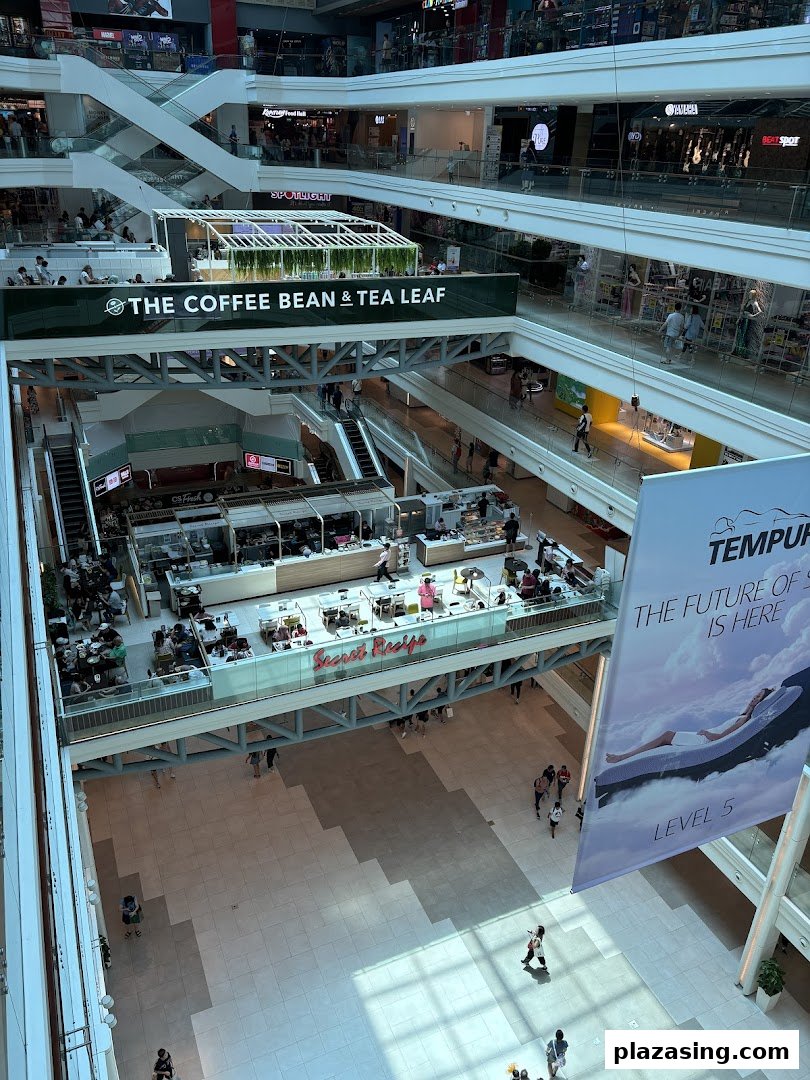 Aerial view of a bustling mall interior featuring Secret Recipe cafe with patrons enjoying their meals.