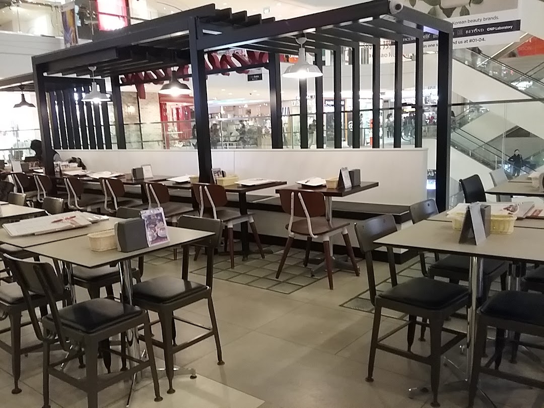 Spacious indoor dining area of Secret Recipe with multiple tables and chairs, ready for guests.