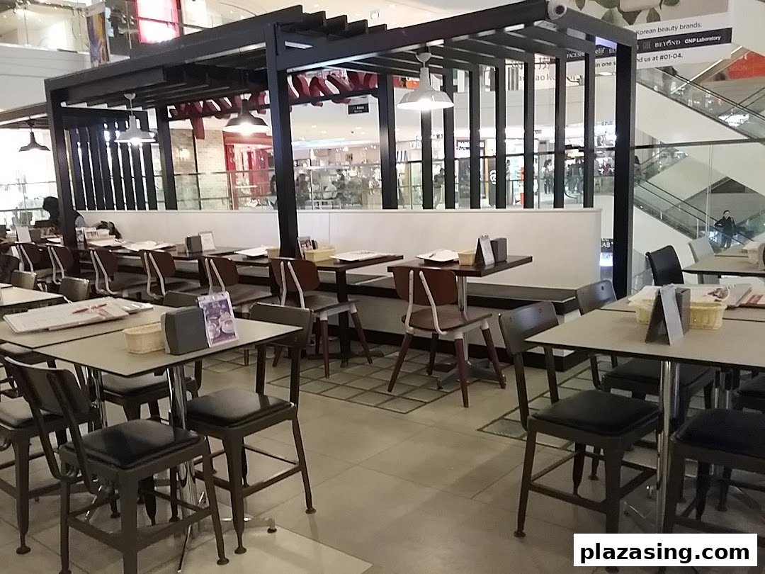 Spacious indoor dining area of Secret Recipe with multiple tables and chairs, ready for guests.