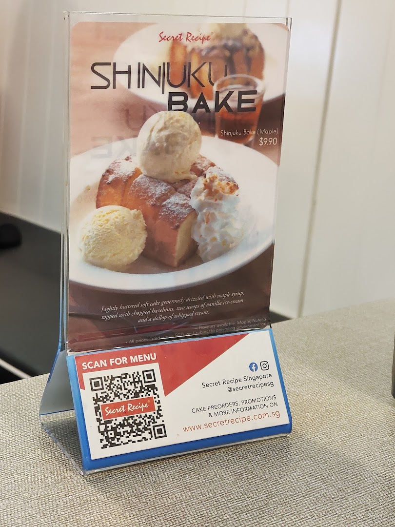 A table-top display showcasing Secret Recipe's Shinjuku Bake dessert with price and details.