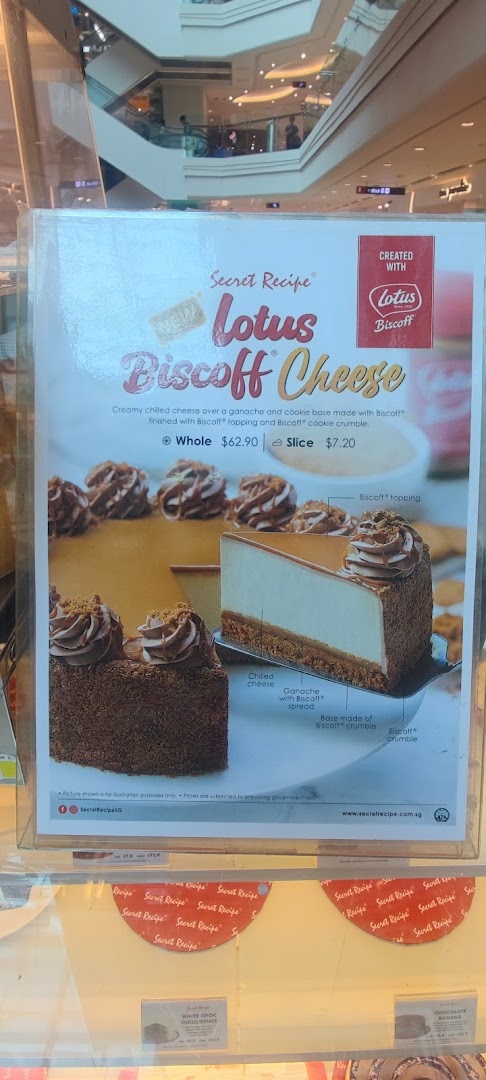 A promotional poster for Secret Recipe's Lotus Biscoff Cheese cake, with other cake prices visible.