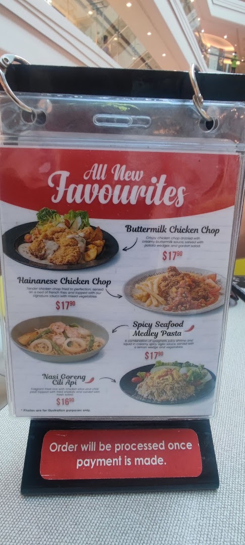 A close-up of Secret Recipe's 'All New Favourites' menu board displaying four main dishes with prices.