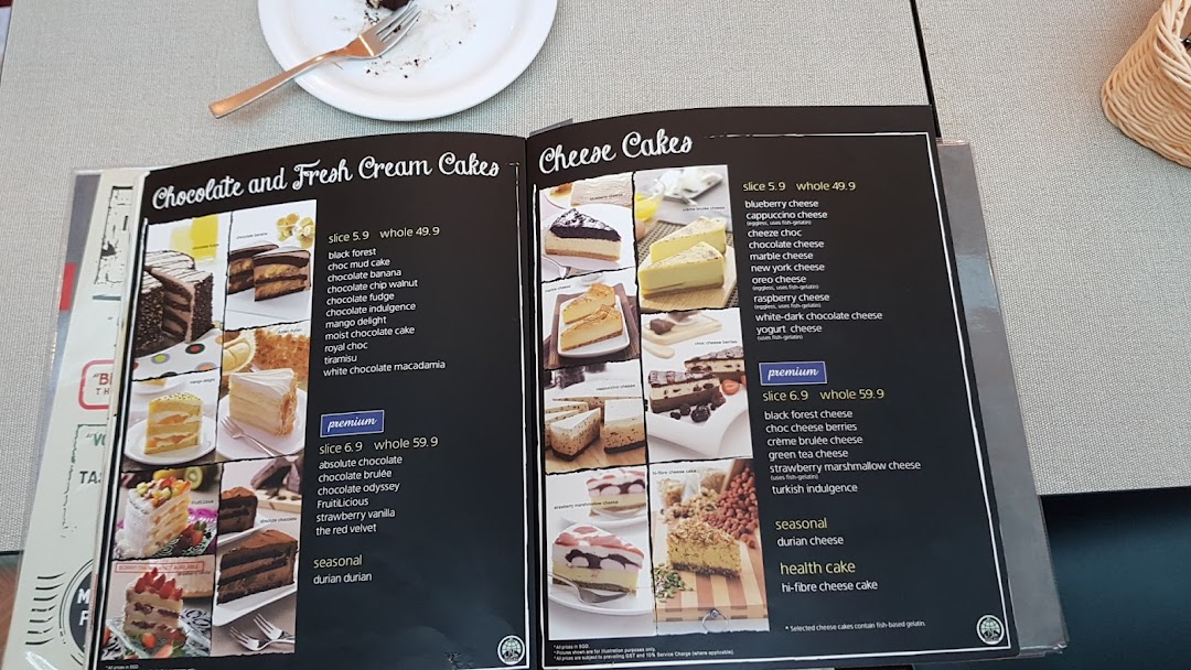 A Secret Recipe menu displaying various chocolate, fresh cream, and cheese cakes with prices.