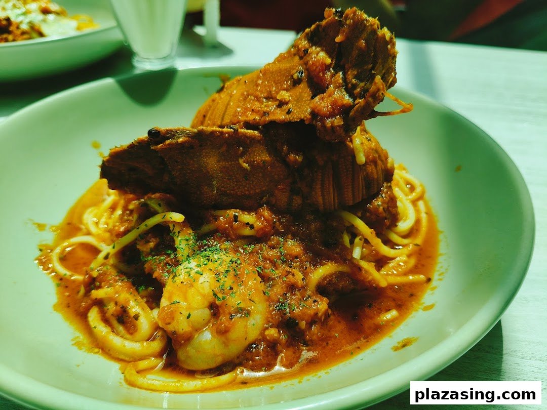 A vibrant seafood pasta dish featuring a large crustacean, shrimp, and squid in a rich red sauce.