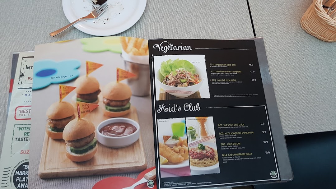 A close-up view of Secret Recipe's menu, featuring vegetarian and kids' meal options.