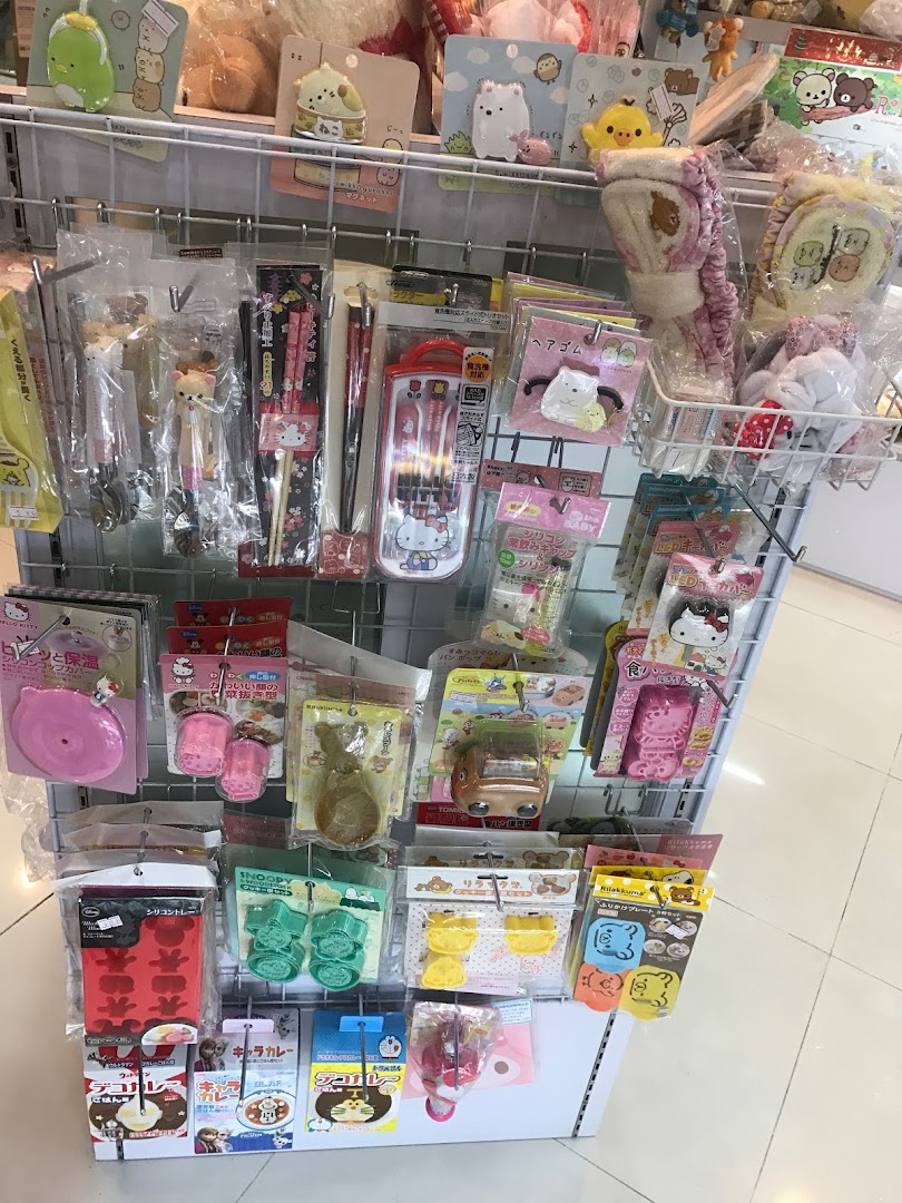 A retail display rack filled with various Japanese character-themed kitchenware, stationery, and accessories.