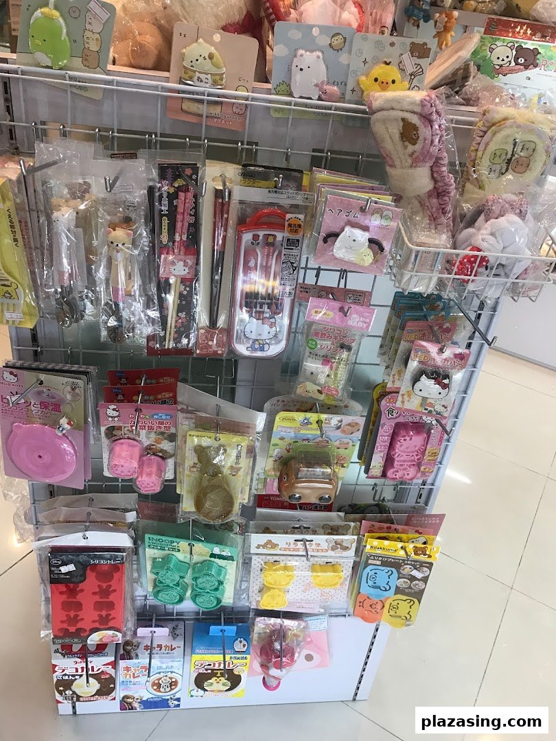 A retail display rack filled with various Japanese character-themed kitchenware, stationery, and accessories.
