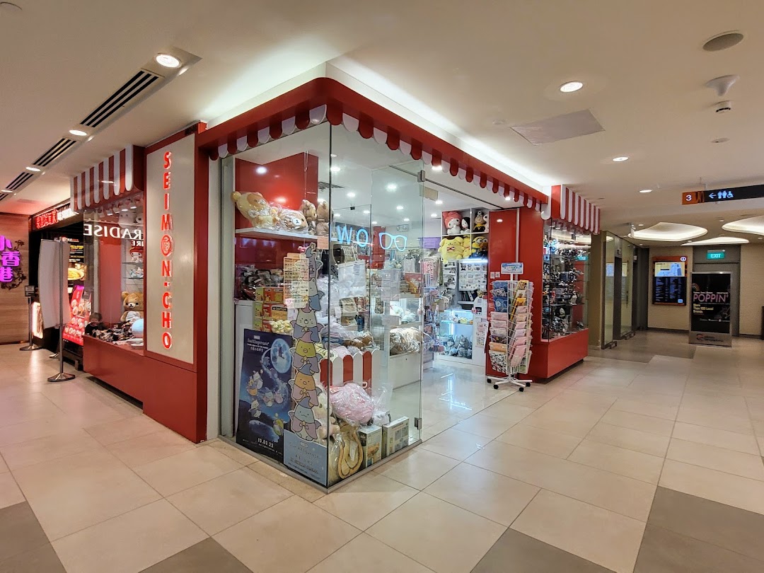 The vibrant red and white striped facade of Seimon-Cho, a shop filled with cute plush toys and merchandise, in a mall.