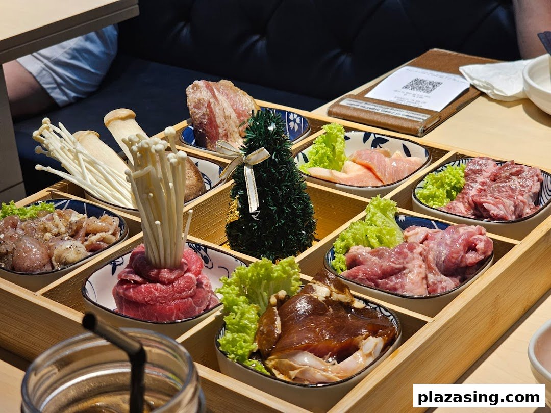 A wooden tray filled with various raw meats, mushrooms, and lettuce, ready for Korean BBQ.