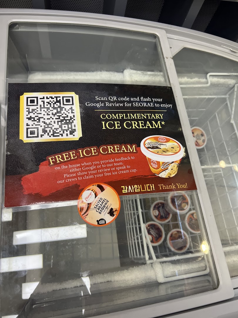 A freezer displaying a promotional sign for complimentary ice cream with a Google review.