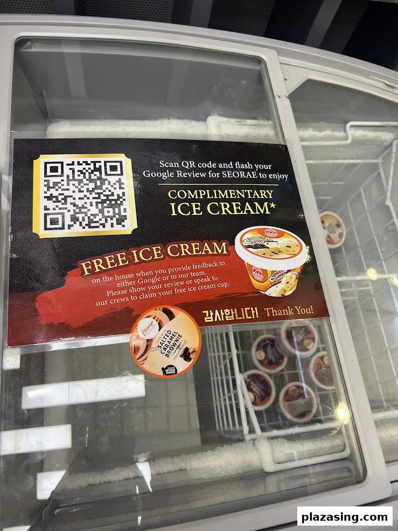 A freezer displaying a promotional sign for complimentary ice cream with a Google review.