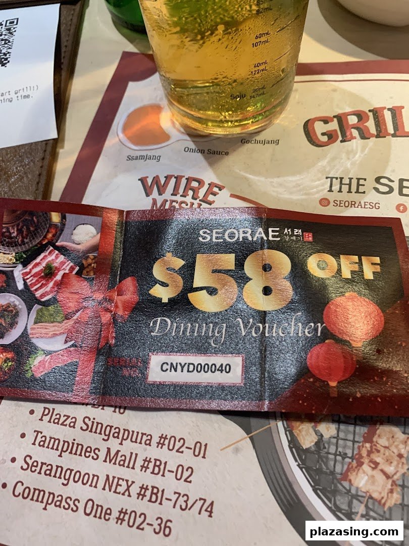 A Seorae Jib dining voucher for $58 off, displayed on a table with a drink and placemat.