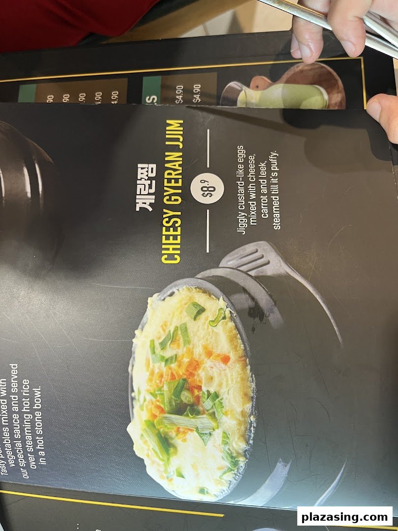 A close-up of a menu page featuring Cheesy Gyeran Jjim with its description and price.
