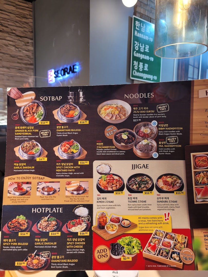 A detailed menu displaying various Korean dishes including sotbap, noodles, hotplates, and jjigae.