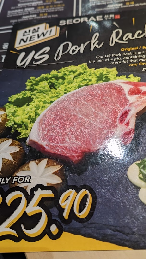 A menu page featuring a 'NEW!' US Pork Rack dish with lettuce and mushrooms.