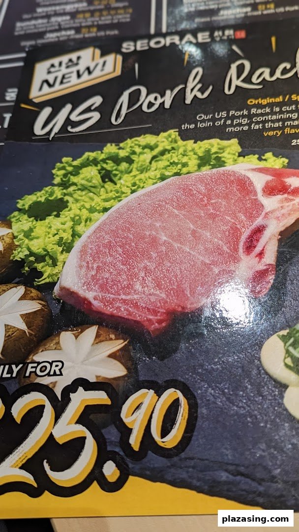 A menu page featuring a 'NEW!' US Pork Rack dish with lettuce and mushrooms.