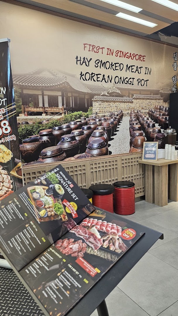 Interior view of Seorae Jib featuring a large wall mural and a menu stand.