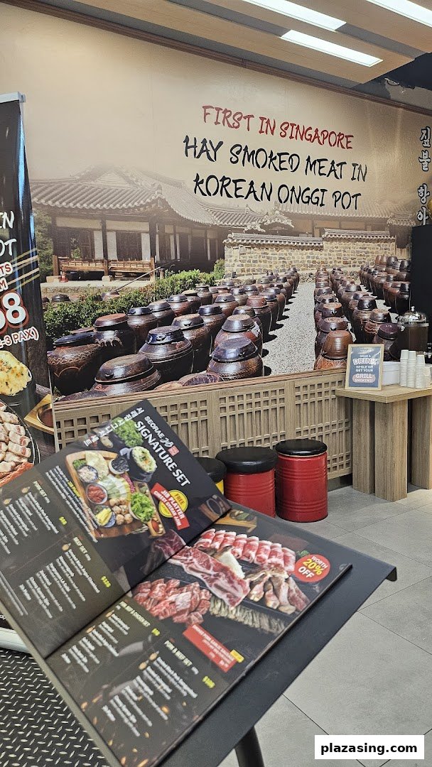 Interior view of Seorae Jib featuring a large wall mural and a menu stand.