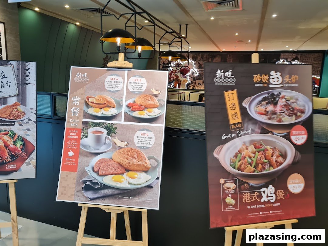 Large display boards showcasing various delicious food items and daily sets inside a restaurant.