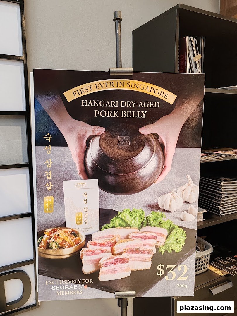 A promotional standee showcasing Seorae Jib's Hangari Dry-Aged Pork Belly, priced at $32 for 200g.