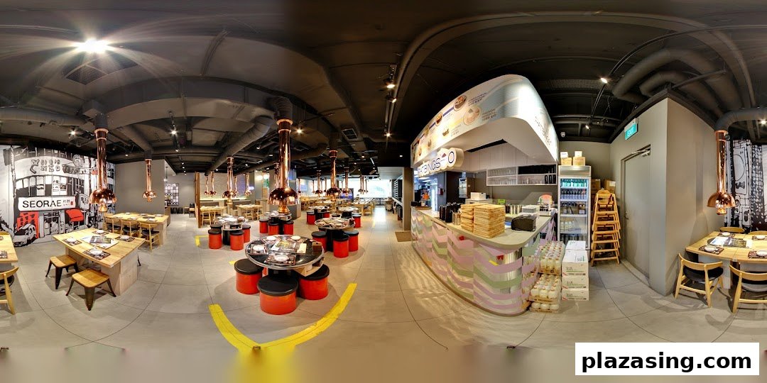 A wide-angle view of Seorae Jib's modern Korean BBQ restaurant interior with various seating arrangements.