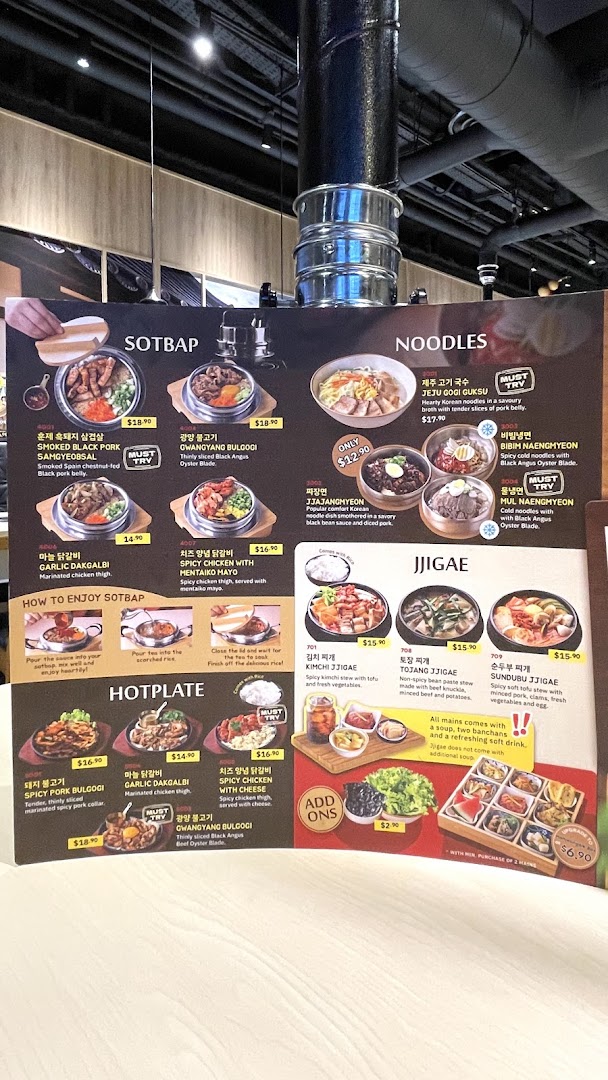 A vibrant menu board showcasing a variety of Korean dishes including SOTBAP, Noodles, Jjigae, and Hotplate.