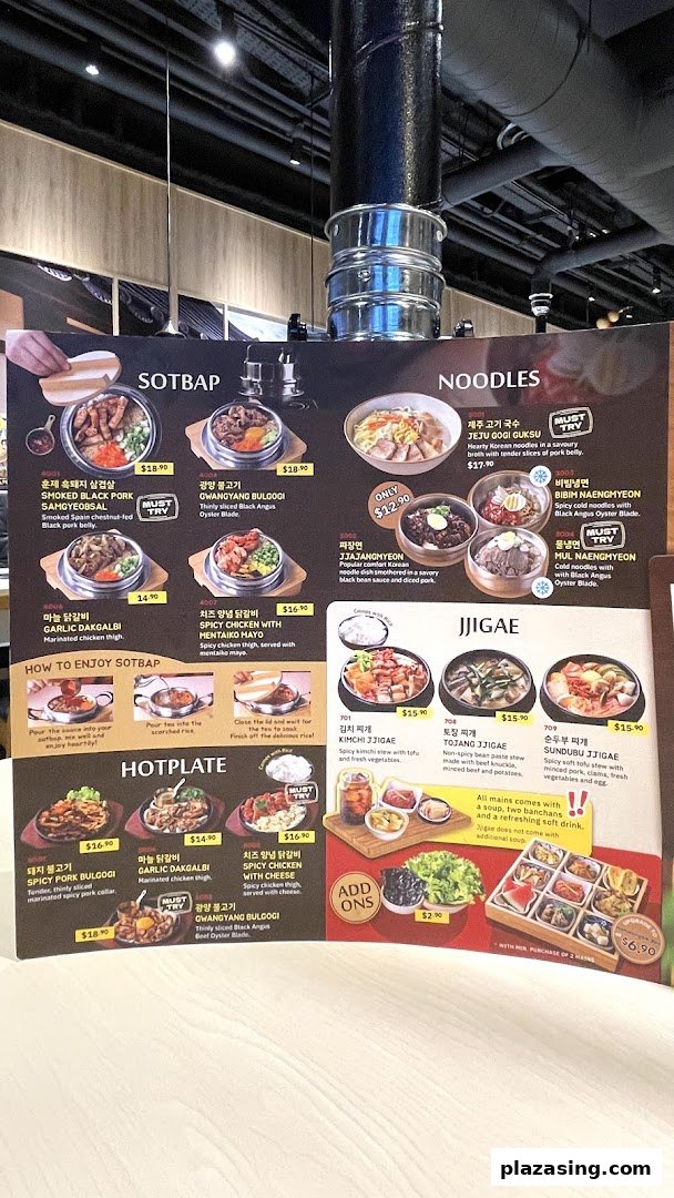 A vibrant menu board showcasing a variety of Korean dishes including SOTBAP, Noodles, Jjigae, and Hotplate.