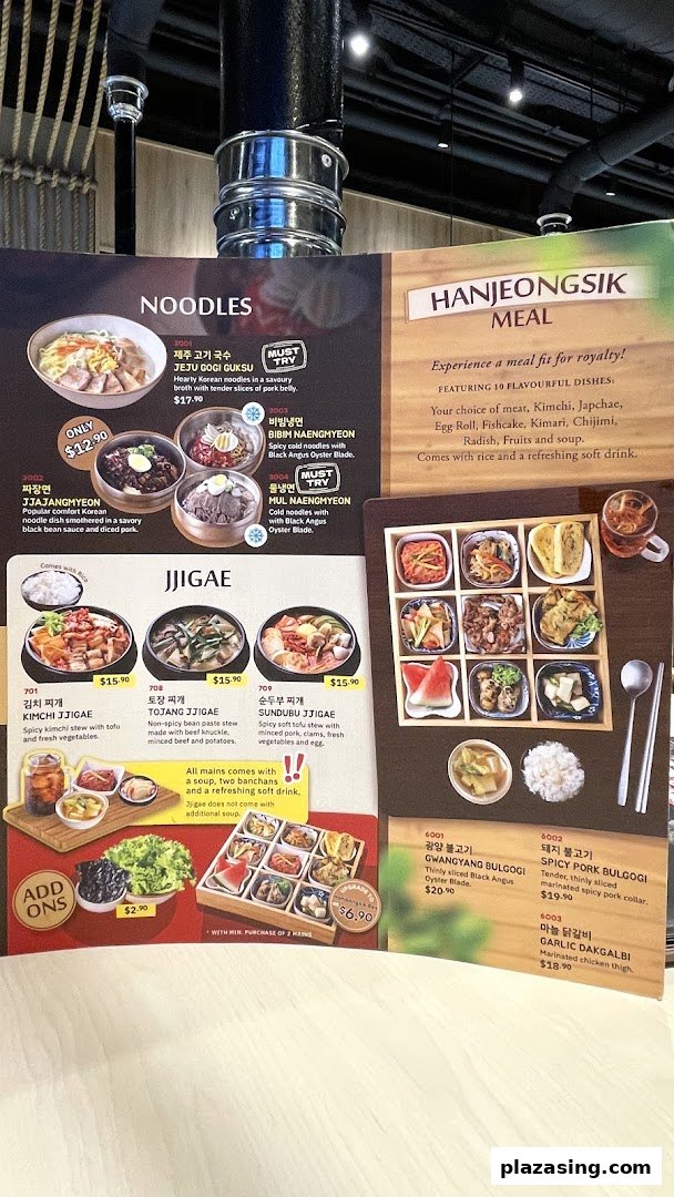 A vibrant Korean restaurant menu displaying various noodle dishes, stews, and grilled meats.