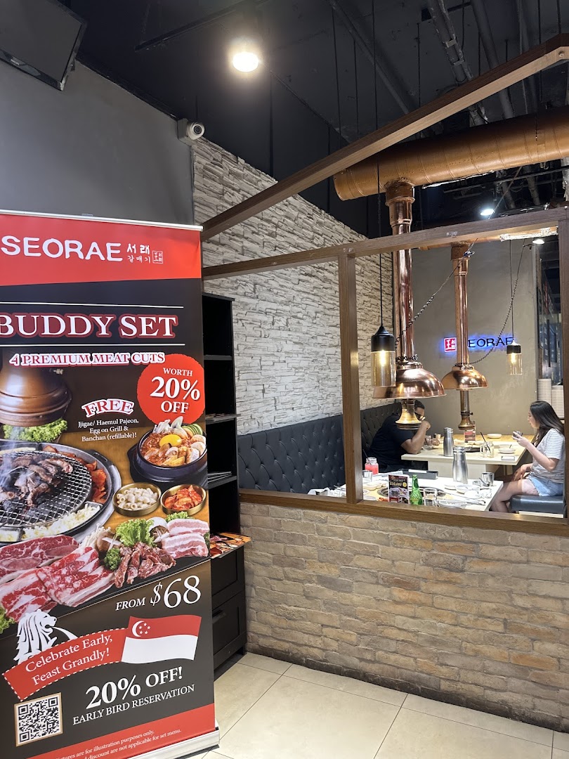 An inviting interior view of Seorae Jib, featuring diners and a promotional banner for a Buddy Set.