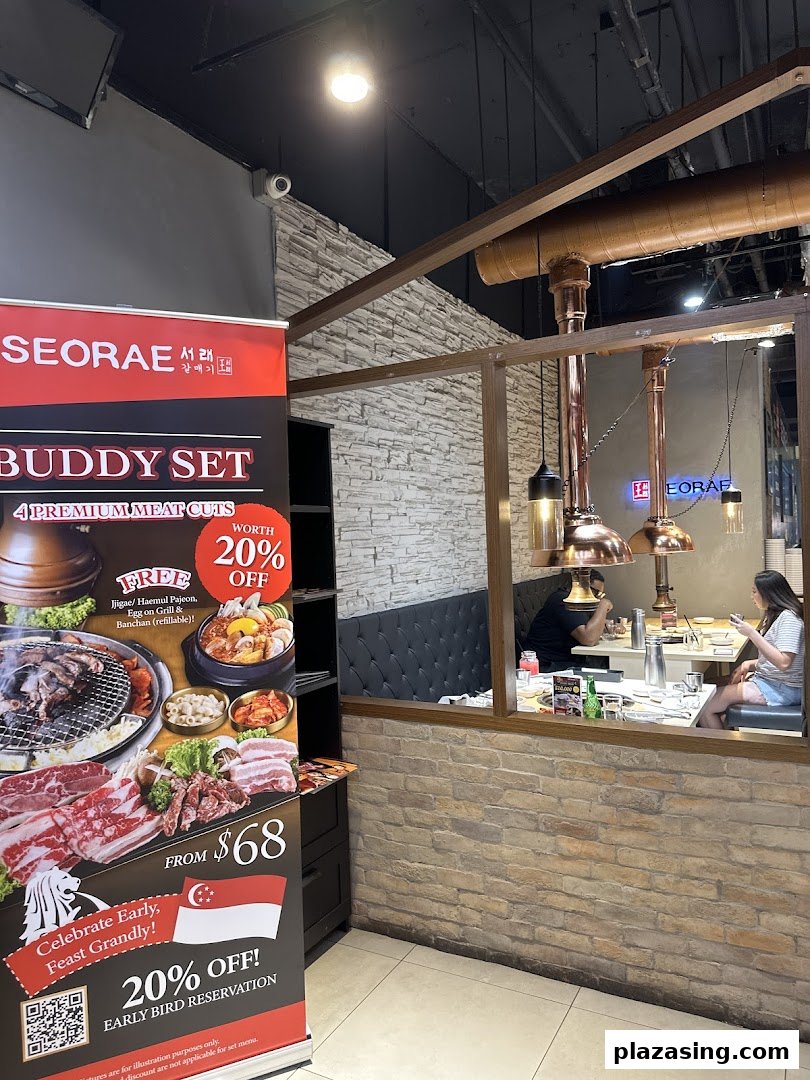 An inviting interior view of Seorae Jib, featuring diners and a promotional banner for a Buddy Set.
