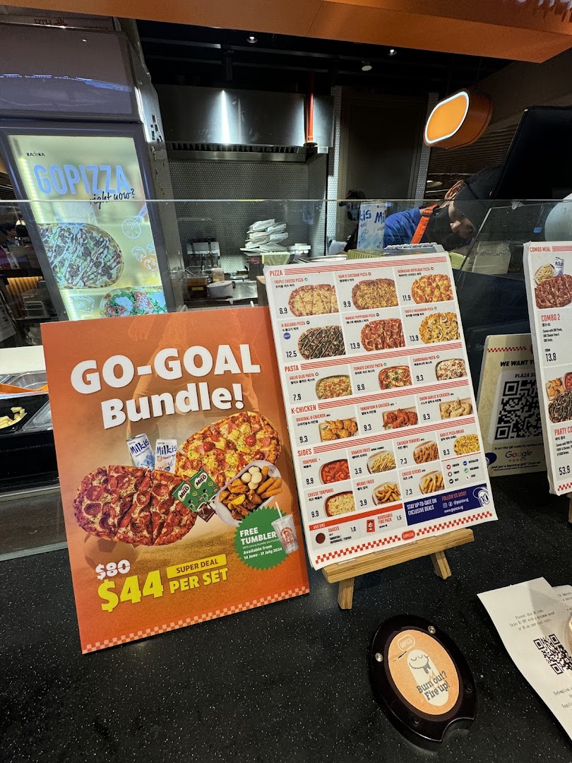 A counter display at GOPIZZA featuring menus, a promotional bundle, and a queue buzzer.