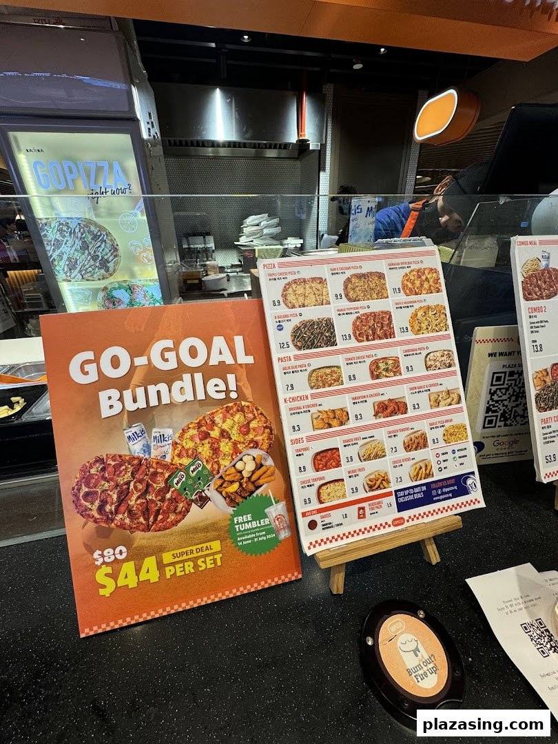 A counter display at GOPIZZA featuring menus, a promotional bundle, and a queue buzzer.