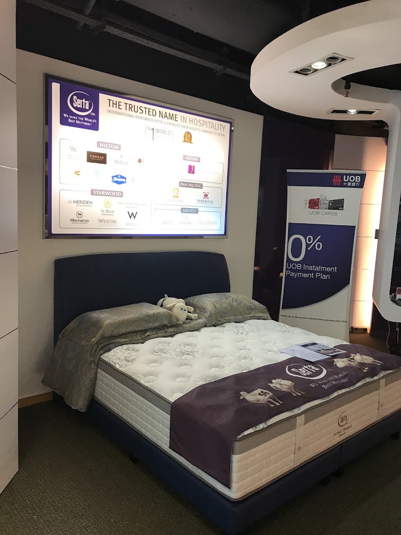 A Serta mattress display featuring a bed, promotional banner, and a list of hospitality partners.