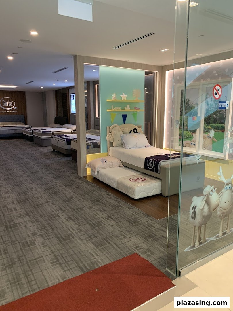 Interior view of Serta Sleep Center showcasing various mattresses and beds, including a children's sleep display.