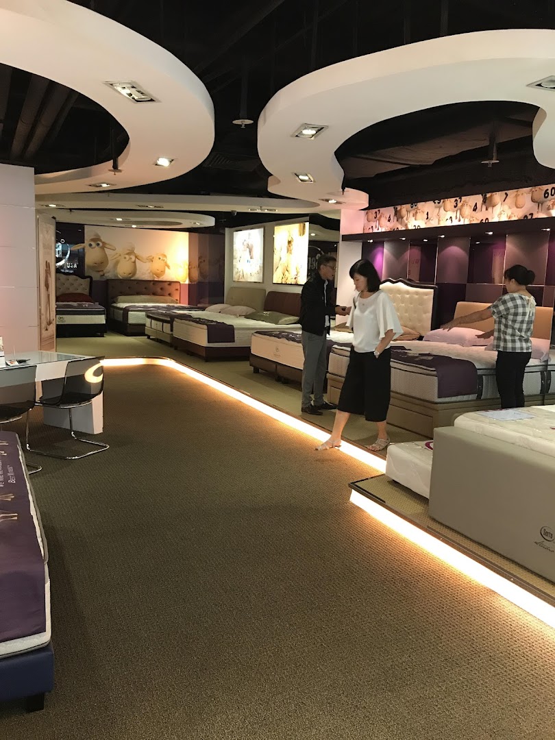 Customers browse a wide selection of mattresses and beds in the Serta Sleep Center showroom.