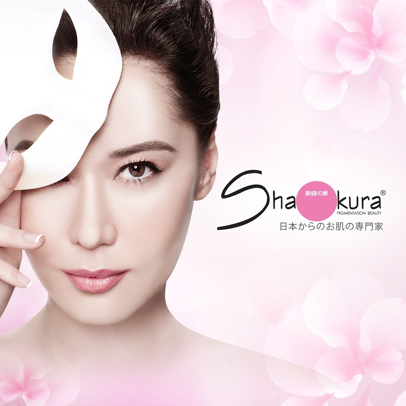 A woman with clear skin holds a mask, showcasing the Shakura Pigmentation Beauty logo and branding.