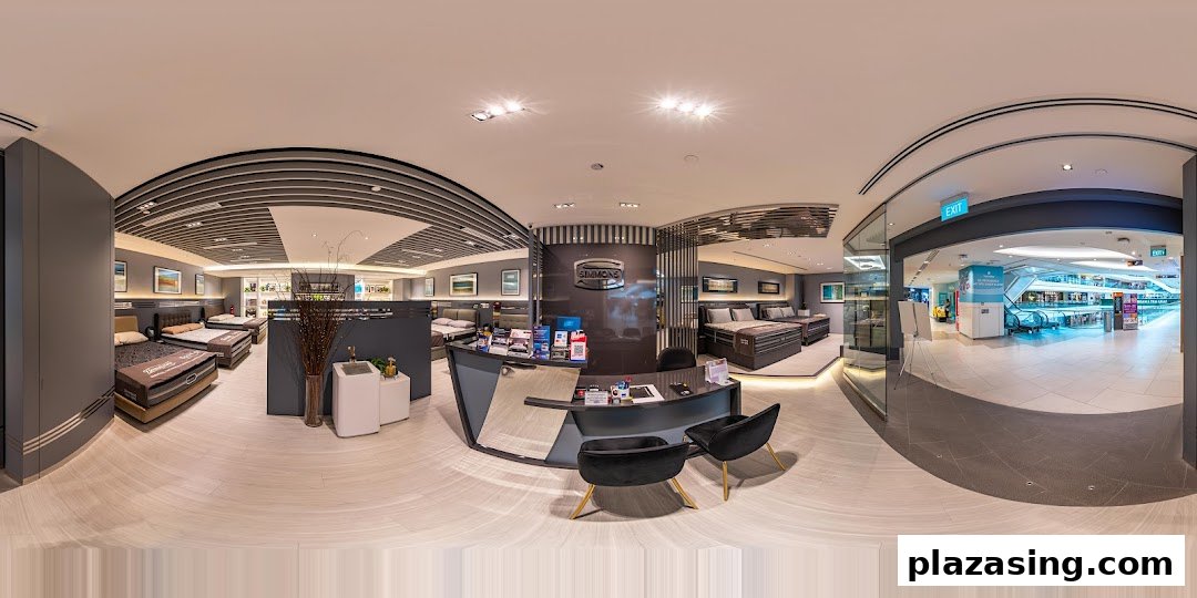 An interior panoramic view of Simmons Studio, showcasing various mattresses, beds, and a reception desk.