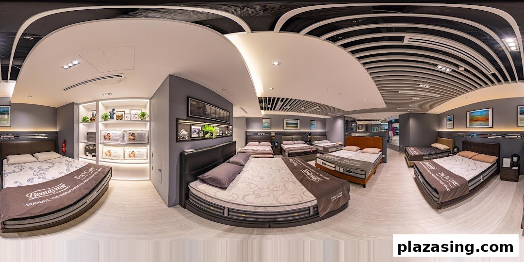 A wide-angle view of the Simmons Studio showroom, featuring various mattresses and bed frames on display.