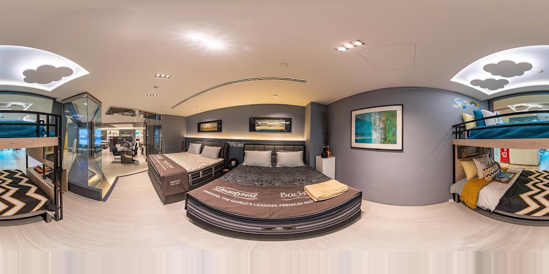 An interior view of Simmons Studio, showcasing various beds and mattresses in a modern showroom setting.