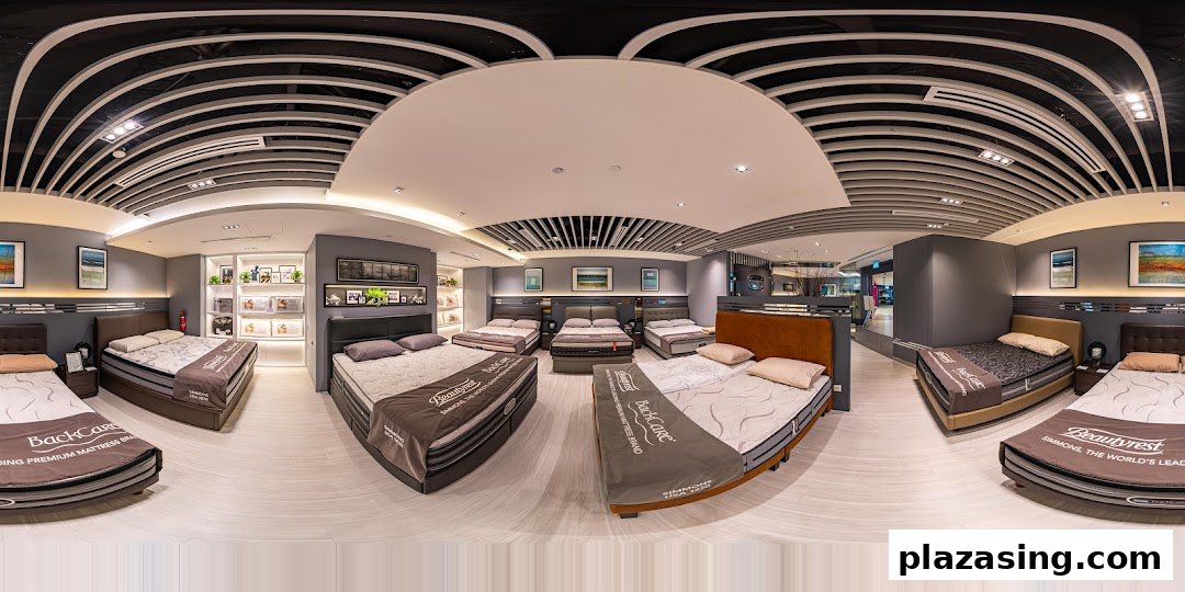 A wide-angle view of the Simmons Studio showroom, showcasing various mattresses and bed frames in a modern setting.