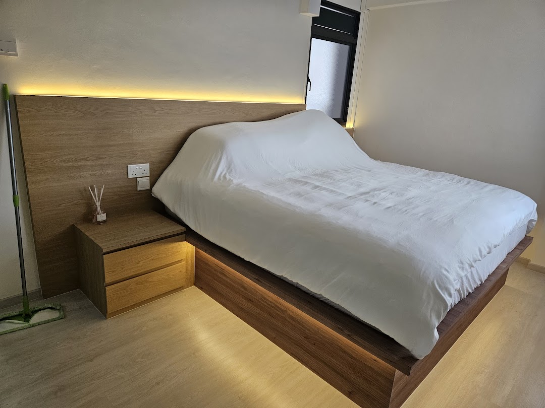A modern bedroom setup featuring a wooden bed frame with integrated lighting and a matching bedside table.