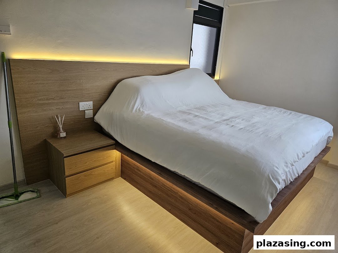 A modern bedroom setup featuring a wooden bed frame with integrated lighting and a matching bedside table.