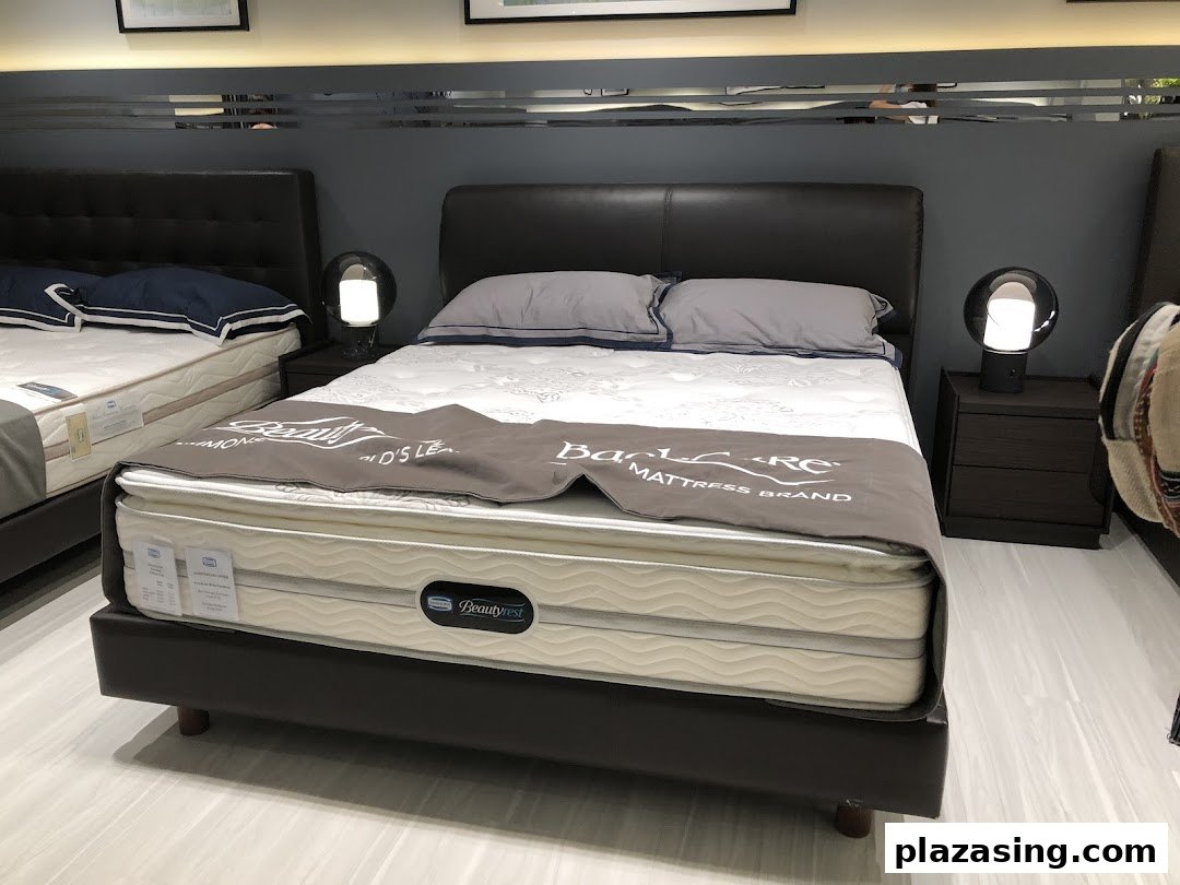 A showroom display featuring multiple beds with mattresses, showcasing comfort and quality sleep solutions.