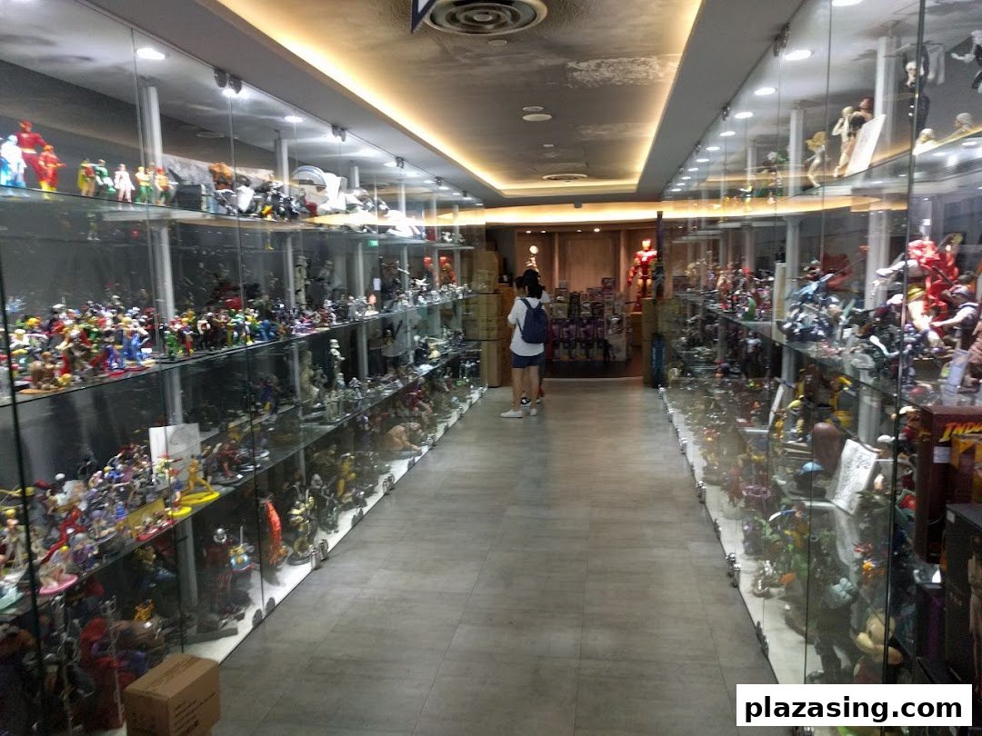 An interior view of Simply Toys, showcasing extensive collections of action figures and statues in glass display cases.
