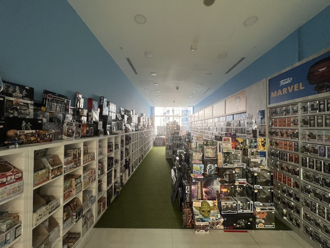 Interior view of Simply Toys, showcasing long aisles filled with diverse toys and collectibles, including Funko Pop figures.