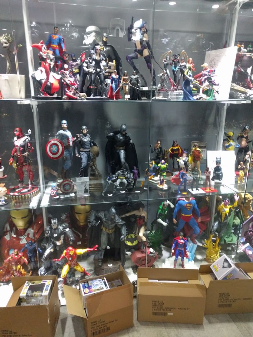 A vibrant display of superhero and pop culture action figures and collectibles in glass cases.
