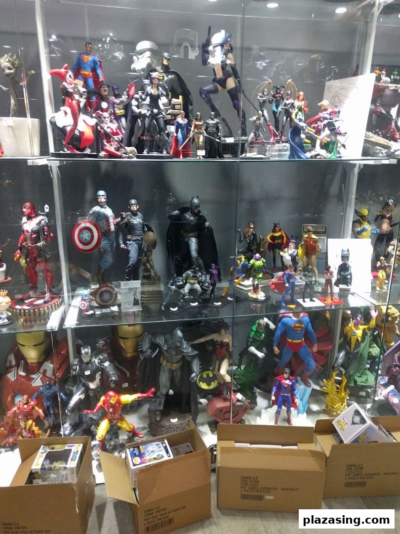A vibrant display of superhero and pop culture action figures and collectibles in glass cases.
