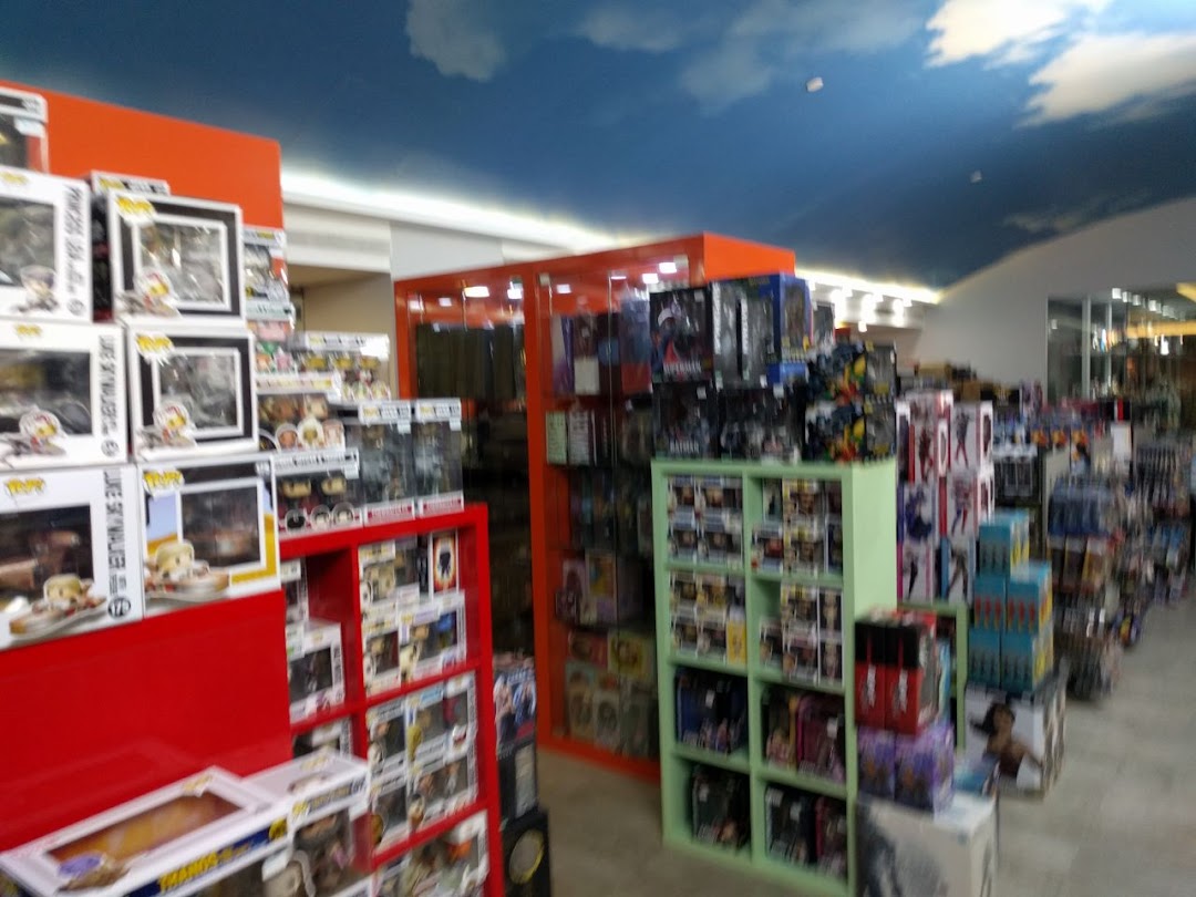 Interior view of Simply Toys showcasing shelves packed with collectible figures and toys under a cloud-painted ceiling.